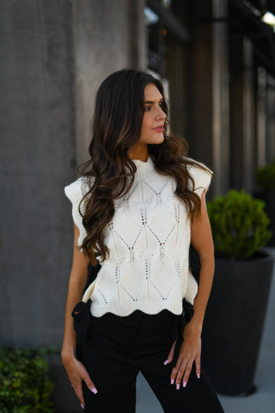 CABLE KNIT SCALLOPED VEST WITH CONTRAST SIDE BOW - CREAM
